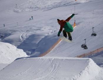 Skier doing tricks on ramp of snow